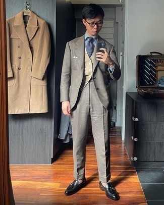Men's Outfits 2021: Dress in a grey suit and a beige sweater vest to look like a true style maverick. Black leather tassel loafers can immediately play down a smart look.