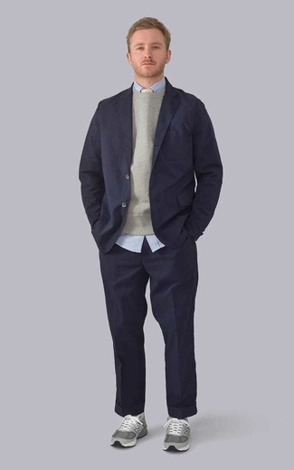 Navy Suit Outfits: Pairing a navy suit with a grey sweatshirt is an on-point pick for a dapper and classy ensemble. Introduce a more relaxed feel to by rounding off with a pair of grey athletic shoes.