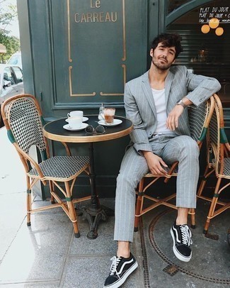 Light Blue Vertical Striped Suit Outfits: Show that you do classic and casual men's style like a pro by opting for a light blue vertical striped suit and a white tank. Clueless about how to finish? Complete this look with a pair of black and white canvas low top sneakers for a more casual take.
