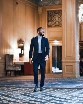 Navy Suit Outfits: This pairing of a navy suit and a grey turtleneck is ideal when you need to look polished and incredibly sharp. Clueless about how to finish? Introduce a pair of navy and white athletic shoes to the mix for a more laid-back finish.