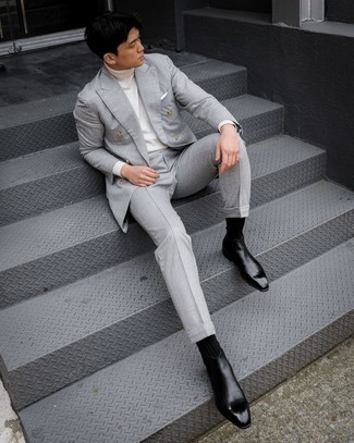 White Turtleneck Outfits For Men: Go all out in a white turtleneck and a grey suit. When not sure as to what to wear on the shoe front, round off with black leather chelsea boots.