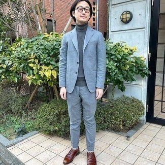 Grey Suit Outfits: Marrying a grey suit and a charcoal turtleneck is a guaranteed way to infuse your styling arsenal with some rugged refinement. Dark brown leather derby shoes integrate smoothly within a variety of combinations.