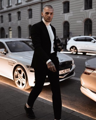 Black Suit Outfits: This pairing of a black suit and a white turtleneck is a never-failing option when you need to look like a British gent. Add a pair of black leather derby shoes to the equation et voila, the ensemble is complete.