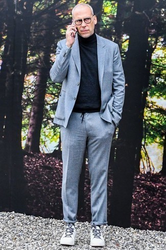 Grey Wool Suit with White Leather Low Top Sneakers Smart Casual Outfits: We're loving the way this combo of a grey wool suit and a black turtleneck immediately makes any gent look stylish and polished. For a more relaxed aesthetic, why not throw white leather low top sneakers in the mix?