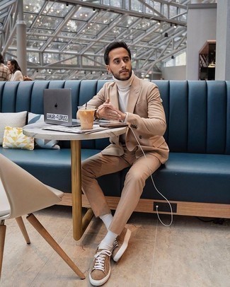 Dark Brown Canvas Low Top Sneakers Outfits For Men: Definitive proof that a tan suit and a white turtleneck look amazing together in a classy look for a modern gent. Go ahead and complement this outfit with dark brown canvas low top sneakers for a more casual touch.