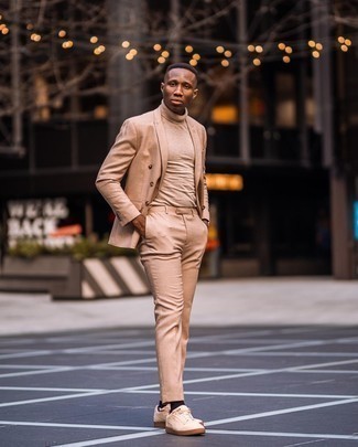 Beige Turtleneck Outfits For Men: This pairing of a beige turtleneck and a tan suit is a surefire option when you need to look incredibly sharp and refined. In the footwear department, go for something on the relaxed end of the spectrum and complete your getup with a pair of beige canvas low top sneakers.