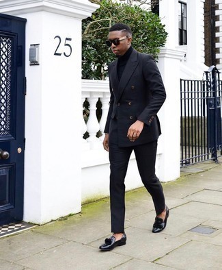 Navy Suit Outfits: This combo of a navy suit and a navy turtleneck is the definition of rugged sophistication. The whole outfit comes together if you finish with black leather tassel loafers.