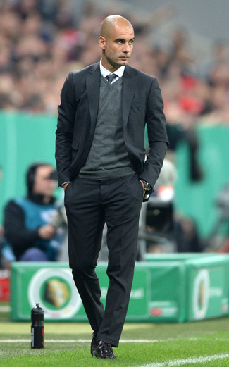 Pep Guardiola wearing Black Suit, Charcoal V-neck Sweater, White Dress Shirt, Black Leather Oxford Shoes