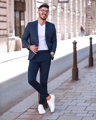 White V-neck T-shirt Outfits For Men: Such items as a white v-neck t-shirt and a navy suit are an easy way to infuse extra sophistication into your day-to-day lineup. Feeling brave? Shake things up by slipping into a pair of white canvas low top sneakers.