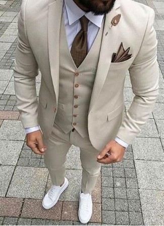 White Leather Low Top Sneakers Dressy Outfits For Men: Pair a beige suit with a beige waistcoat - this look is bound to make ladies swoon. And if you wish to instantly dial down your look with footwear, complement your ensemble with a pair of white leather low top sneakers.