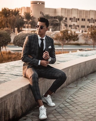White Leather Low Top Sneakers Dressy Outfits For Men: This pairing of a charcoal plaid suit and a black waistcoat is a tested option when you need to look truly stylish and refined. Feeling venturesome? Spice things up by slipping into white leather low top sneakers.