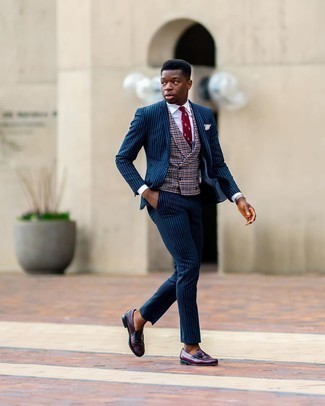 Multi colored Check Waistcoat Outfits: You're looking at the definitive proof that a multi colored check waistcoat and a navy vertical striped suit are amazing when worn together in a polished ensemble for a modern gentleman. To add a mellow vibe to your ensemble, add burgundy leather loafers to the equation.