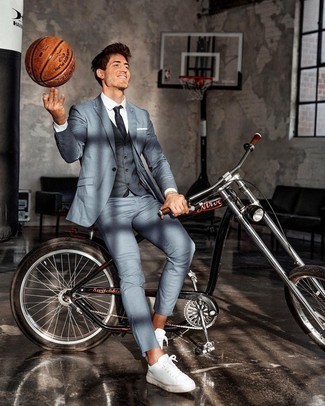 Light Blue Suit Outfits: This sophisticated combination of a light blue suit and a charcoal waistcoat is a favored choice among the fashion-forward gents. Add a pair of white canvas low top sneakers to the equation to easily turn up the street cred of this look.