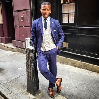 Navy Suit Outfits: Marrying a navy suit with a beige plaid waistcoat is an on-point idea for a classic and polished look. Does this look feel too perfect? Let a pair of brown leather loafers jazz things up.
