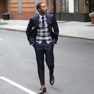 Navy Suit Outfits: This is hard proof that a navy suit and a navy plaid waistcoat look amazing if you pair them together in a refined outfit for a modern dandy. With shoes, go for something on the casual end of the spectrum and complement this outfit with a pair of brown leather monks.