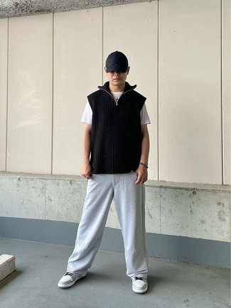 Black Sweater Vest Outfits For Men: Marrying a black sweater vest with grey sweatpants is an on-point idea for a casually stylish getup. Feeling venturesome today? Spice things up by finishing with grey leather low top sneakers.