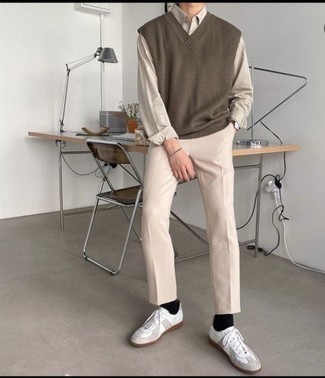 500+ Warm Weather Outfits For Men: This combo of a brown sweater vest and beige chinos is solid proof that a safe getup can still be incredibly smart. Add a more relaxed feel to by rounding off with white leather low top sneakers.
