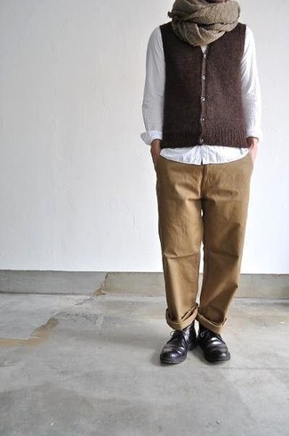 Brown Sweater Vest Outfits For Men: This combination of a brown sweater vest and khaki chinos might pack a punch, but it's also very easy to put together. To give your overall ensemble a more casual touch, slip into dark brown leather desert boots.