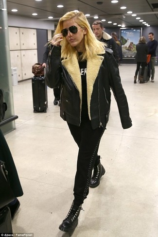Ellie Goulding wearing Black Leather Lace-up Flat Boots, Black Sweatpants, Black and White Print Crew-neck Sweater, Black Shearling Jacket