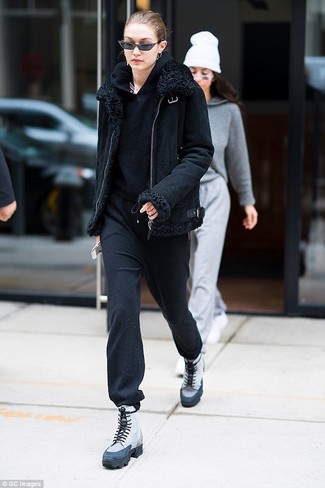Gigi Hadid wearing Grey Leather Lace-up Flat Boots, Black Sweatpants, Black Hoodie, Black Shearling Jacket