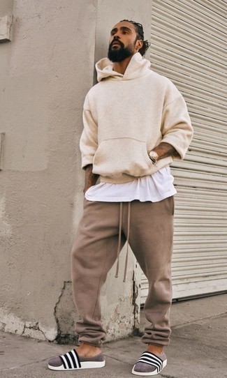 Men's White and Black Horizontal Striped Rubber Sandals, Brown Sweatpants, White Tank, Beige Hoodie