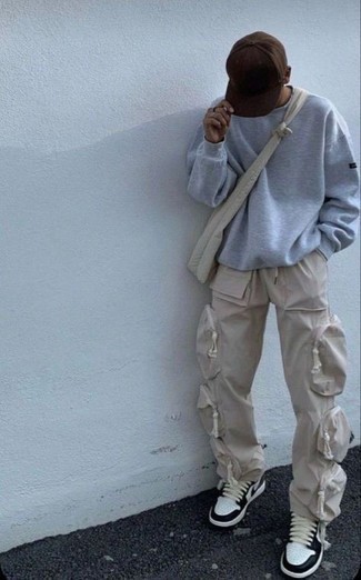Beige Cargo Pants Outfits: This combination of a grey sweatshirt and beige cargo pants is extremely easy to imitate and so comfortable to work as well! Complement this outfit with a pair of white and black leather low top sneakers and the whole ensemble will come together.