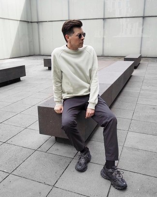 Beige Sweatshirt Outfits For Men: Go for a simple but at the same time casually cool getup by marrying a beige sweatshirt and charcoal chinos. Take a more relaxed approach with footwear and introduce a pair of black athletic shoes to the equation.