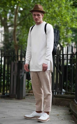 Black Canvas Backpack Outfits For Men: This casual pairing of a white sweatshirt and a black canvas backpack is a foolproof option when you need to look stylish in a flash. Get a bit experimental in the shoe department and add a pair of white leather derby shoes to your ensemble.