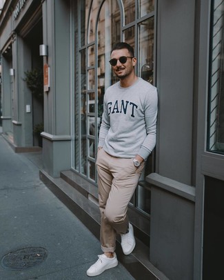 Grey Print Sweatshirt Outfits For Men: Go for a simple yet casually dapper option pairing a grey print sweatshirt and beige chinos. White leather low top sneakers are a stylish complement for this ensemble.