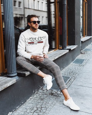 White Print Sweatshirt Outfits For Men: This is solid proof that a white print sweatshirt and grey plaid chinos look awesome when matched together in a casual look. White leather low top sneakers will tie the whole thing together.