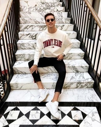 White and Red Print Sweatshirt Outfits For Men: For an ensemble that's super straightforward but can be manipulated in many different ways, rock a white and red print sweatshirt with black chinos. A pair of white leather low top sneakers integrates nicely within a multitude of looks.