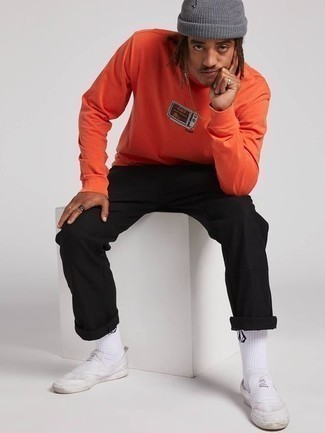Orange Sweatshirt Outfits For Men: For an ensemble that's pared-down but can be manipulated in a great deal of different ways, choose an orange sweatshirt and black chinos. Finish off with white canvas slip-on sneakers and ta-da: the ensemble is complete.