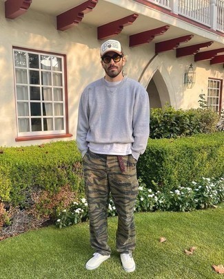 White Print Baseball Cap Outfits For Men: In situations comfort is critical, this combination of a grey sweatshirt and a white print baseball cap is always a winner. Complete your look with a pair of white canvas low top sneakers for a dose of elegance.