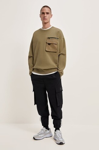 Beige Sweatshirt Outfits For Men: One of the coolest ways for a man to style a beige sweatshirt is to pair it with black cargo pants in a casual combo. Bring a more relaxed twist to this look by finishing with grey athletic shoes.