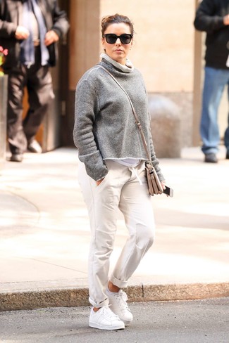 Grey Leather Crossbody Bag Outfits: Indisputable proof that a grey sweatshirt and a grey leather crossbody bag look awesome when you pair them up in a casual ensemble. White leather low top sneakers will bring a dash of sultry refinement to this ensemble.