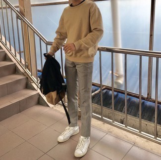 White and Green Leather Low Top Sneakers Outfits For Men: This relaxed casual combo of a tan sweatshirt and grey chinos takes on different forms depending on how you style it. When in doubt as to the footwear, introduce a pair of white and green leather low top sneakers to the equation.