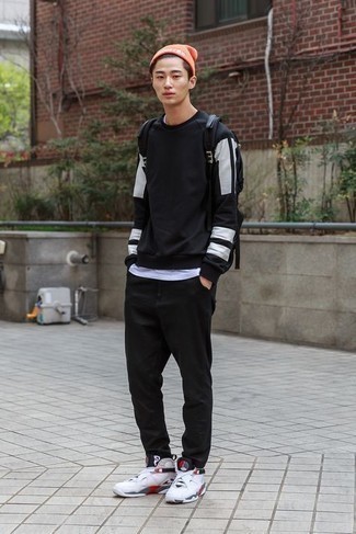 Black Sweatshirt Outfits For Men: This combination of a black sweatshirt and black chinos is proof that a safe off-duty ensemble doesn't have to be boring. For times when this outfit appears all-too-dressy, dress it down with white athletic shoes.