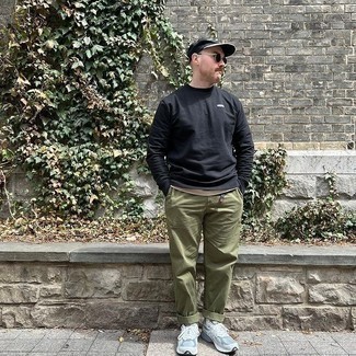 Sweatshirt Outfits For Men: Fashionable and functional, this relaxed pairing of a sweatshirt and olive chinos will provide you with excellent styling possibilities. Follow a more casual route in the shoe department by wearing light blue athletic shoes.