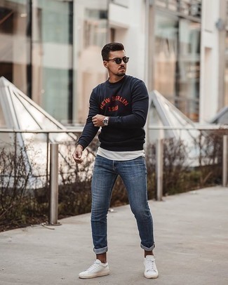 Navy and White Print Sweatshirt Outfits For Men: This combo of a navy and white print sweatshirt and blue jeans is the ultimate casual style for any guy. When in doubt about the footwear, stick to white canvas low top sneakers.