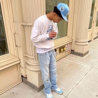 Light Blue Baseball Cap Outfits For Men: A white print sweatshirt and a light blue baseball cap are a wonderful pairing to add to your daily off-duty routine. Dial down the casualness of this getup with a pair of white and blue athletic shoes.