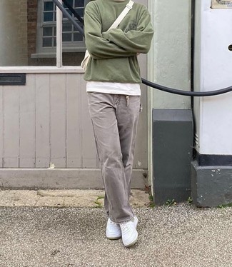 Beige Canvas Fanny Pack Outfits For Men: If you love casual style, why not dress in an olive sweatshirt and a beige canvas fanny pack? Introduce a pair of white leather low top sneakers to the mix to easily up the classy factor of any look.