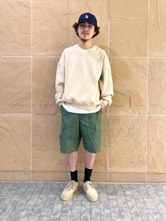 Dark Green Shorts Outfits For Men: A beige sweatshirt and dark green shorts are a cool ensemble to keep in your casual collection. If you wish to immediately step up this look with one single piece, complete your outfit with beige suede desert boots.