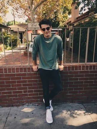 Dark Green Sweater Outfits For Men: This laid-back pairing of a dark green sweater and navy skinny jeans can take on different nuances according to the way you style it out. Feeling transgressive? Change things up a bit by rounding off with a pair of white canvas low top sneakers.
