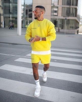 Yellow Sweatshirt Outfits For Men: Who said you can't make a fashionable statement with a city casual outfit? You can do that easily in a yellow sweatshirt and yellow sports shorts. Feeling adventerous? Spice things up with white leather low top sneakers.