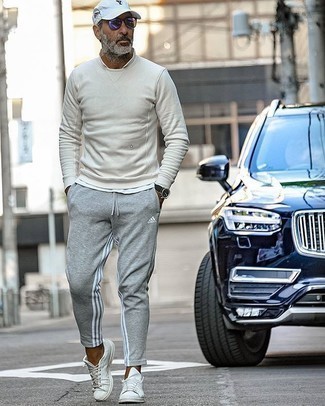 Charcoal Sweatshirt Outfits For Men: A charcoal sweatshirt and grey sweatpants are veritable essentials if you're planning a casual wardrobe that matches up to the highest sartorial standards. A pair of white canvas low top sneakers will be a stylish accompaniment to your look.