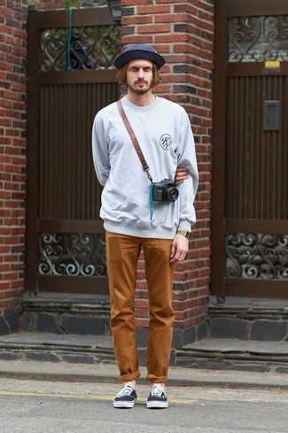 Tobacco Jeans Outfits For Men: You'll be surprised at how easy it is for any man to throw together this casual outfit. Just a grey print sweatshirt combined with tobacco jeans. The whole ensemble comes together really well if you introduce a pair of black and white canvas low top sneakers to the mix.