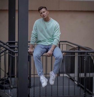 Green Sweatshirt Outfits For Men: For a casual and cool getup, pair a green sweatshirt with light blue jeans — these two items fit really well together. Add white leather low top sneakers to the mix and you're all set looking spectacular.