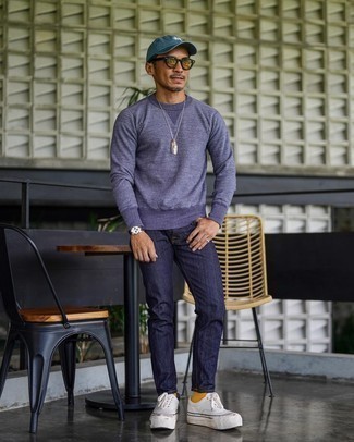 Light Violet Sweatshirt Outfits For Men: Fashionable and comfortable, this casual pairing of a light violet sweatshirt and navy jeans will provide you with wonderful styling opportunities. White canvas low top sneakers are the glue that pulls this outfit together.