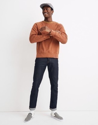 Black Canvas Slip-on Sneakers Outfits For Men: This combo of an orange sweatshirt and navy jeans is definitive proof that a pared down off-duty outfit can still look really interesting. Black canvas slip-on sneakers are a smart choice to finish off this outfit.