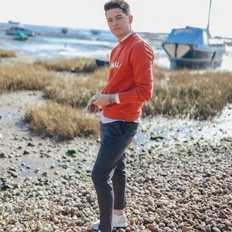 Red Sweatshirt Outfits For Men: Such pieces as a red sweatshirt and charcoal chinos are the ideal way to inject subtle dapperness into your off-duty styling rotation. Complement your outfit with white athletic shoes to give a sense of stylish casualness to your ensemble.